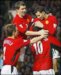 Phil Neville, Roy Keane and Ryan Giggs congratulate Ruud van Nistelrooy