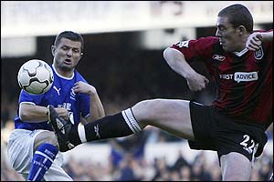 Everton's Tomasz Radzinski clashes with Manchester City's Richard Dunne