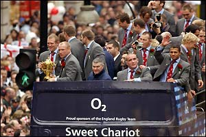 The players take pictures from the top of the bus