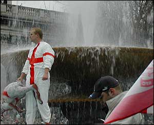 Fan stood in fountain holding inflatable kangaroo