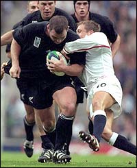New Zealand's Anton Oliver is tackled by Wilkinson during the Rugby World Cup in 1999