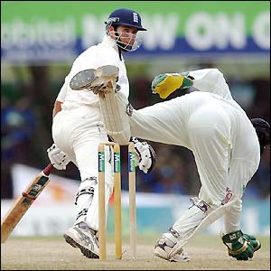 England skipper Michael Vaughan watches Sri Lankan wicket-keeper Kumar Sangakkara stoop for the ball 