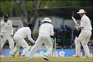 Andrew Flintoff turns round to watch as his is bowled by Muralitharan