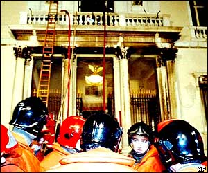 Exhausted firefighters survey the damage to the opera house from the fire 