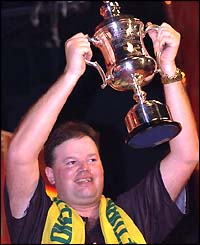 Raymond van Barneveld shows off the trophy in 2003