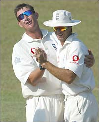 Ashley Giles celebrates the wicket of Hashan Tillakaratne with Michael Vaughan