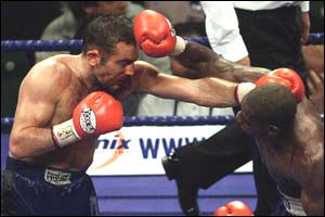 Harrison on his way to an early career victory over former world champion Tom 