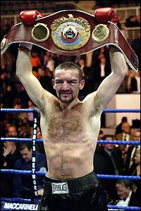 Harrison proudly parades the WBO featherweight belt