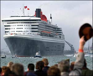 Queen Mary 2 sails into Southampton surrounded by flotilla of smaller ships