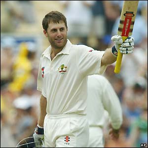 Simon Katich raises his bat to the crowd after reaching his century