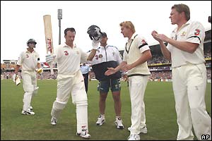 Steve Waugh's Australian team-mates come onto the pitch to applaud their captain off 