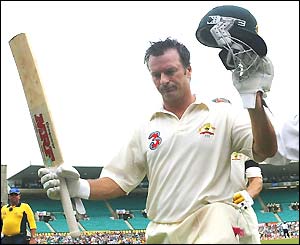 Steve Waugh raises his bat as he walks off the pitch after making 80 in his final Test innings
