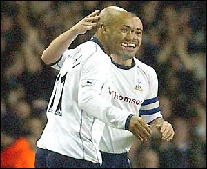 Stephane Dalmat of Spurs is congratulated on his goal by Stephen Carr