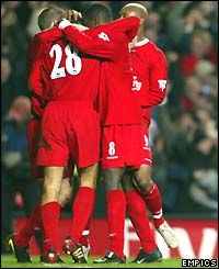 Liverpool mob Bruno Cheyrou (hidden) after he scores the only goal of the game