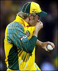 Australia's Michael Clarke kisses his shirt after clinching the VB Series victory over India