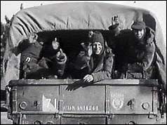 Troops waving from the back of army truck