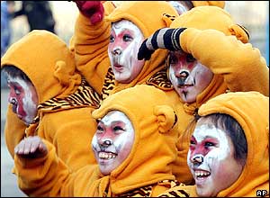 Children dressed as monkeys pose for photos at a temple fair in Beijing 