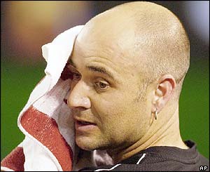 Andre Agassi wipes his face