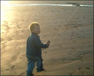Three-year-old Osian Owens flying a kite at Sandy Haven Beach, Milford Haven in west Wales (Adrian Owens)