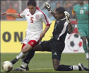 Tunisia's Zied Jaziri challenges Senegal goalie Tony Silva