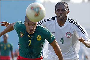Cameroon defender Joel Doumbe Perrier fights for the ball with Nigerian forward Nwankwo Kanu