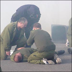 Army personnel and police officer in protective clothing
