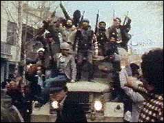 Civilians brandishing guns on an armoured car