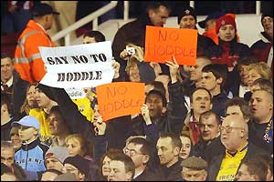 Southampton fans hold signs protesting about rumours hinting at the return of former manager Glenn Hoddle