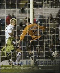 Alan Smith bundles the ball into the back of the net to give Leeds the lead