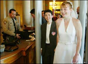 Davina Koltulski (L) and Mollie McKay (R) pass through a metal detector as they make their way to obtain a marriage license