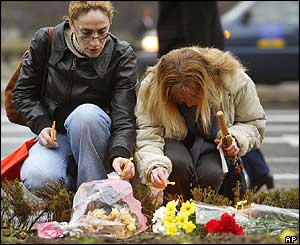 Women light candles in front of the parliament building in Skopje.