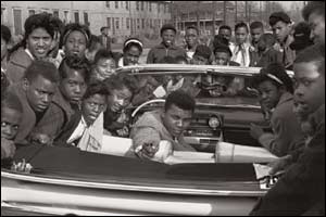 Cassius Clay, loved by children. Photo 1962 � Howard L. Bingham 