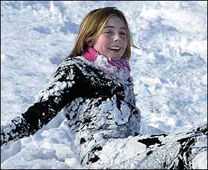 Young girl plays in snow