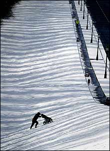 Man pushes pram in snow