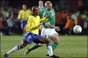 Brazil's Ze Roberto tries to get the ball away from Graham Kavanagh