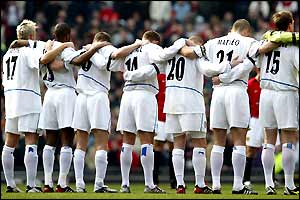 Leeds players line up for a minute's silence prior to kick off
