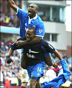 Olivier Tebily climbs on Birmingham goalscorer Stern John's back in celebration