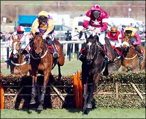 Brave Inca (left) ridden by Barry M Cash clears the final fence to win the opening race of the festival