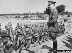 Adolf Hitler salutes his troops as they march towards Poland