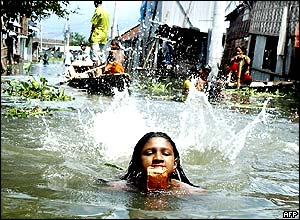 A girl swims through Bangladesh's flooded streets.