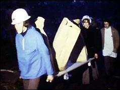 Remains of crash victims are carried away on a stretcher