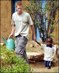 Mutsu Potsane shows Prince Harry around the Mantsase Childrens Home for orphans.