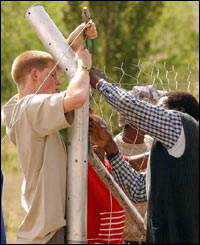 The fun-loving prince helps erect a fence.