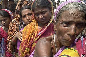 Flood-affected people queue for the medical check by Indian Army doctors in Assam