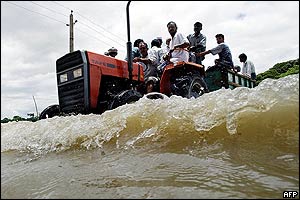 Bangladeshi villagers on a tractor along the flooded Brahmanbaria-Comilla highway