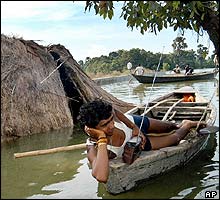 A flood victim beside his submerged house in the Samastipur District, in the eastern Indian state of Bihar