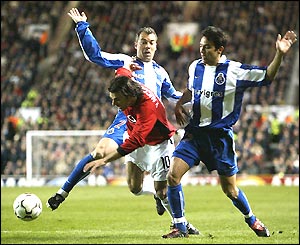 Ruud van Nistelrooy is sandwiched between two Porto defenders
