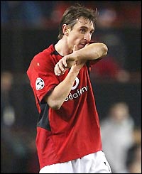 A dejected Gary Neville leaves the field