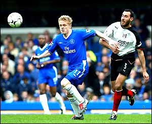 Damien Duff sprints after the ball away from Sylvain Legwinski