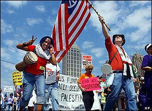 US protester shows the peace sign as another waves a US flag at protest in southern US state of Georgia 